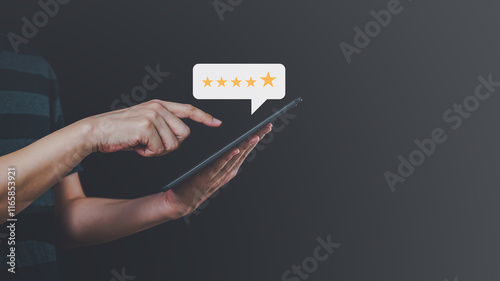 Close up of male customer hand pressing on smartphone screen with golden five star rating feedback icon