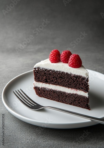 Chocolate cake with raspberries served on a white plate