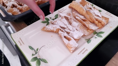 Freshly made angel wings cookies with powdered sugar, a dish for Fat Thursday