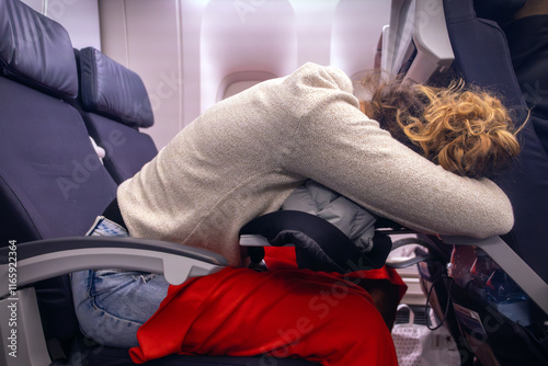 Fotografia Tired passenger sleep uncomfortable in the economy class of the plane