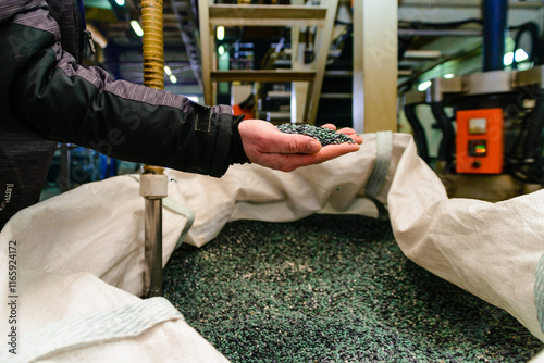 hands hold or touching biodegradable plastic pellets, plastic polymer granules