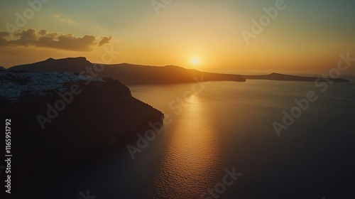 A breathtaking sunset over the serene waters of Santorini, showcasing a golden sky and calm sea.