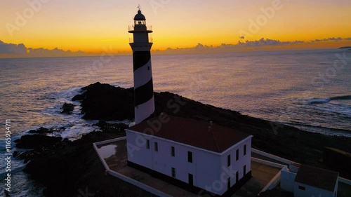 Panoramic Drone View of Favaritx Lighthouse and Rocky Coastline. Faro de Favaritx, Menorca, Spain - Aerial Perspective Capturing Coastal Beauty and Mediterranean