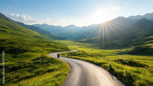 A rider, silhouetted against the fading light, captures the essence of adventure and the beauty of the natural world on a quiet road amidst majestic mountains.