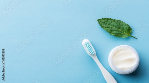 Fresh Mint Toothpaste with Toothbrush and Leaf on a Calm Blue Background for Oral Hygiene and Dental Care Promotion photo