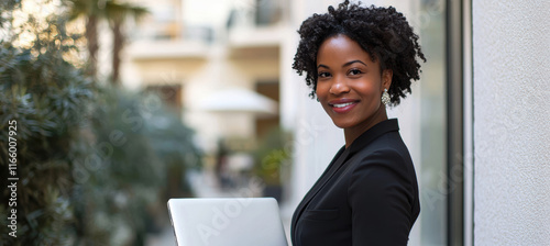 Confident Businesswoman in Modern Suit Holding Laptop Outside Office for Leadership Concept