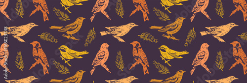Pattern of orange silhouettes of wild forest birds and fir branches. Songbirds, tit, grosbeak, goldfinch and oriole. Yellow and orange fabric engraving of nature motifs. Seamless vector background.