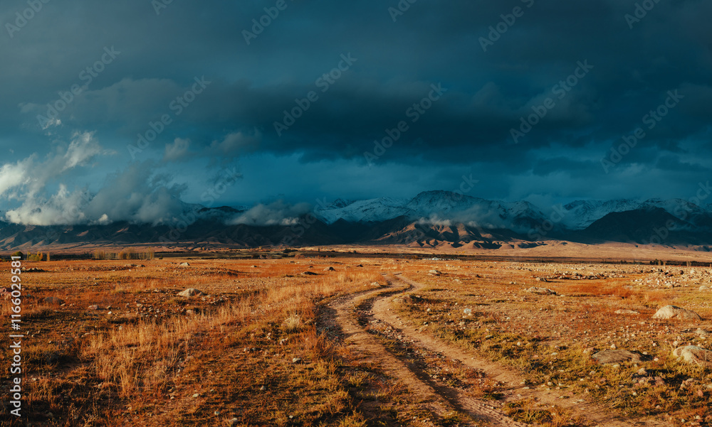 Obraz premium Picturesque landscape with snowy high mountains in autumn, dramatic weather