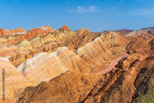 Under the clear sky, the colorful Danxia landforms