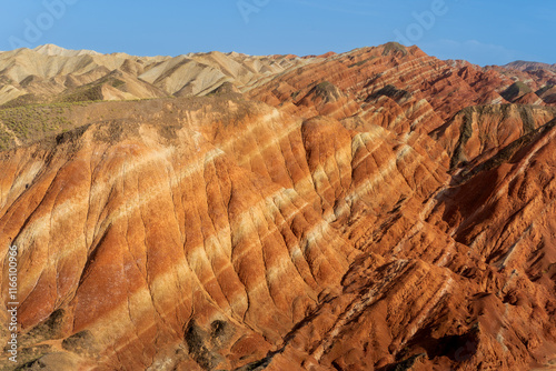 Under the clear sky, the colorful Danxia landforms