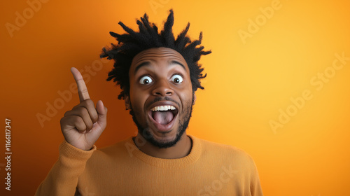 African American man with an excited expression, pointing upwards, symbolizing a new idea