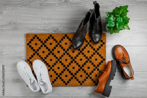 Doormat. Welcome mat on the floor background. Women's shoes on a doormat on background. Interior decor element in the hallway. Close-up. Space for text. Copy space.rug near the door in the hallway.