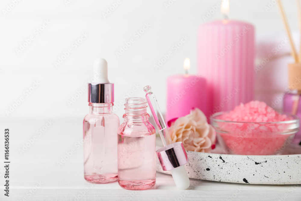 Rose essential oil on a textured background.Roses and a bottle of rose perfumed water.Aromatherapy treatment. Beauty concept. Spa procedure.Natural organic oil.Anti-stress,detox relax.Place for text Rose essential oil on a textured background.Roses and a bottle of rose perfumed water.Aromatherapy treatment. Beauty concept. Spa procedure.Natural organic oil.Anti-stress,detox relax.Place for text
