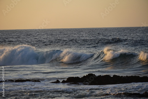 Autumn afternoon watching the sunset and waves from the cliff