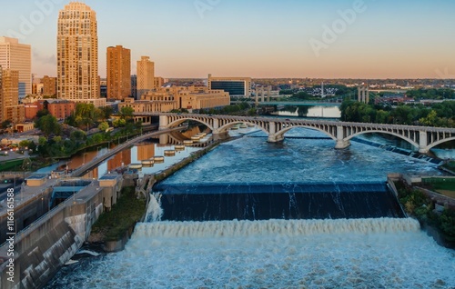 Minneapolis skyline at dawn, St. Anthony Falls dam, powerful water flow. City views, bridges, and the Mississippi River. Upper Pool, Minneapolis, Minnesota, United States