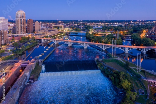 Evening view of the St. Anthony Falls Lock and Dam in Minneapolis, MN. City skyline and bridge in the background. Beautiful twilight colors. Upper Dam, Minneapolis, Minnesota, United States