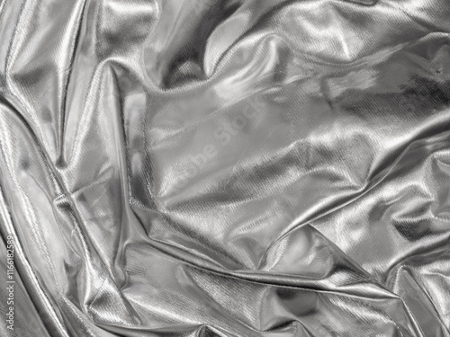 Silver Draped Faux Leather. Pleated Silver Shiny Material. Metallic Fabric With Irregular Folds And Creases. Soft Light. No text. Silver Folded Background. Material With Uneven Folds And Creases. photo