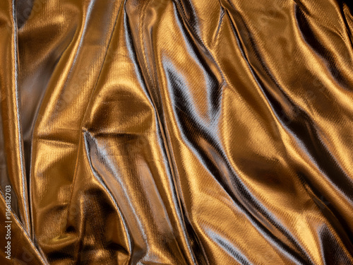 Gold Draped Faux Leather. Pleated Golden Shiny Material. Metallic Fabric With Irregular Folds And Creases. Soft Light. No text. Gold Folded Background. Material With Uneven Folds And Creases.
