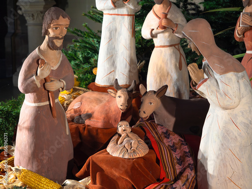 A detailed nativity scene with clay figures depicting the birth of Jesus Christ in the Saints Pierre & Paul Church in Obernai, Alsace