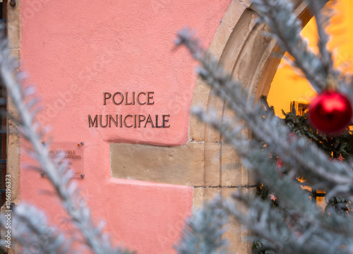 The Turckheim Municipal Police station decorated for Christmas, with a festive tree and ornaments adding a touch of holiday cheer photo