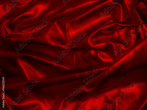 Red Draped Faux Leather. Red Folded Background. Pleated Red Shiny Material. Metallic Fabric With Irregular Folds And Creases. Darkt Light. No text.  Material With Uneven Folds And Creases.