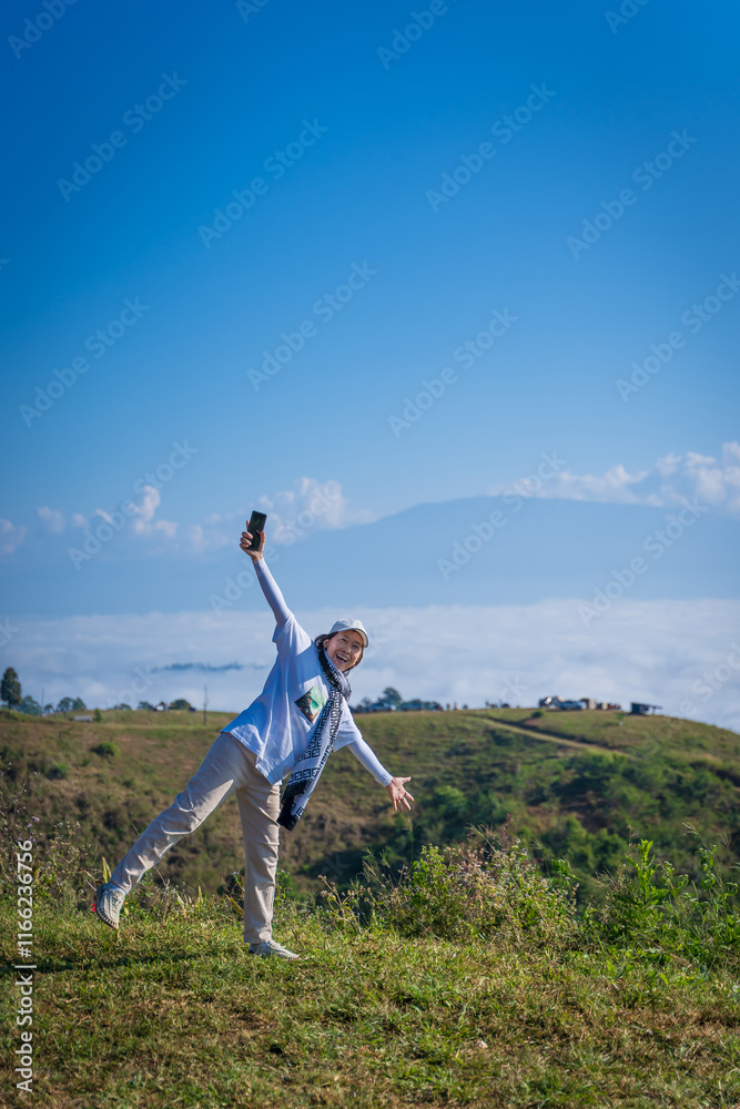 Asian woman relaxing in the morning with beautiful nature scenery of the sea of mist at Campground of Doi Ba Lu Kho Mountain viewpoint in Mae Chaem, Chiang Mai, Thailand. recreation background. Asian woman relaxing in the morning with beautiful nature scenery of the sea of mist at Campground of Doi Ba Lu Kho Mountain viewpoint in Mae Chaem, Chiang Mai, Thailand. recreation background.