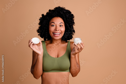 Photo of amazed lady impressed hold cream lotion for soft skin body wear brassiere isolated pastel color background photo