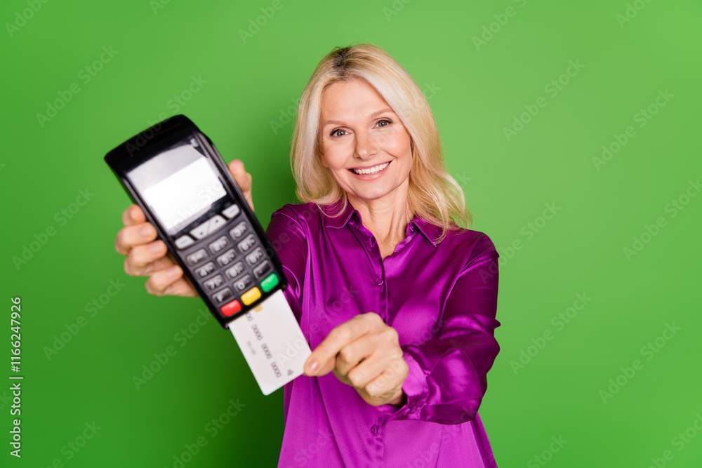 Photo portrait of lovely pensioner lady pay terminal credit card dressed stylish purple satin garment isolated on green color background Photo portrait of lovely pensioner lady pay terminal credit card dressed stylish purple satin garment isolated on green color background