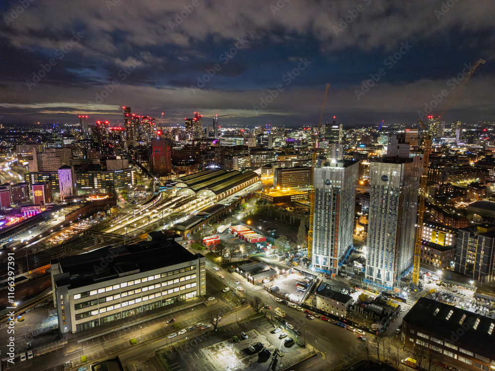 Fototapeta premium An aerial view of a bustling urban area featuring contemporary buildings and lively streets, showcasing the interaction between architecture and everyday city life.