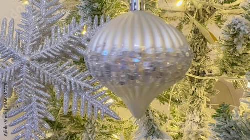 Main decorated Christmas tree with silver ornaments in a cozy festive setting.