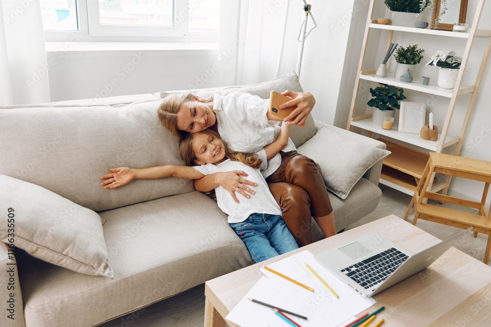 Mother and daughter bonding over a laptop on a cozy couch with a bookshelf in the background Mother and daughter bonding over a laptop on a cozy couch with a bookshelf in the background