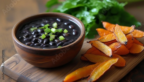 Fresh Caldinho with Black Beans and Sweet Potato Fries on a Wooden Board photo