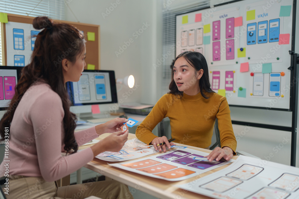 Two female ux ui designers are discussing user interface design for ...