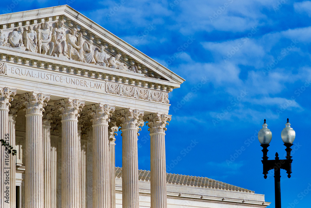 Fototapeta premium The United States Supreme Court building with a cloudy blue sky background.