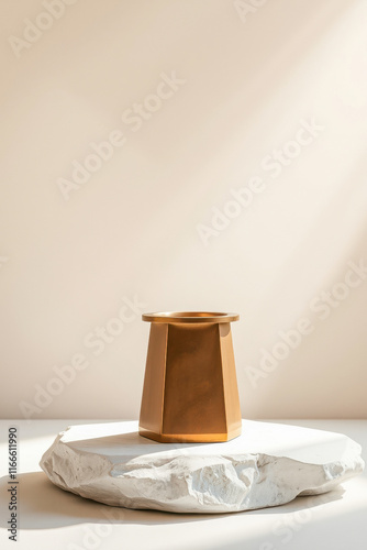 golden geometric container on irregular stone