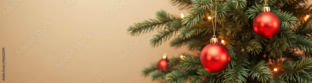 Fototapeta premium three red ornaments adorn a decorated evergreen tree