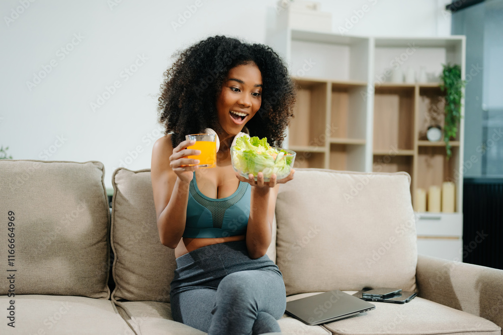 A fit woman enjoys a fresh salad with fruits and juice, embodying wellness, nutrition, and vitality i