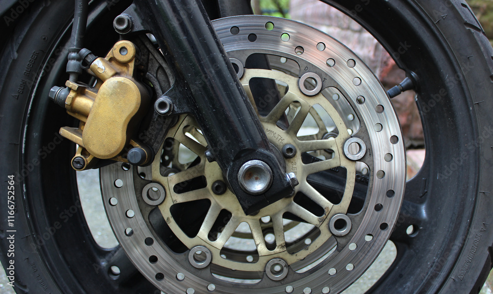 Wear brake disc and damaged caliper on the wheel of motorcycle closeup stock image
Wear brake disc and damaged caliper on the wheel of motorcycle closeup stock image