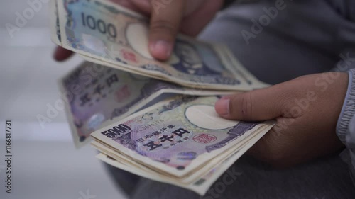 JPY money Japanese Yen banknote Counting in Business people hands for paying shopping salary or payment services, Cash Tax, saving cash for economy finance bill photo