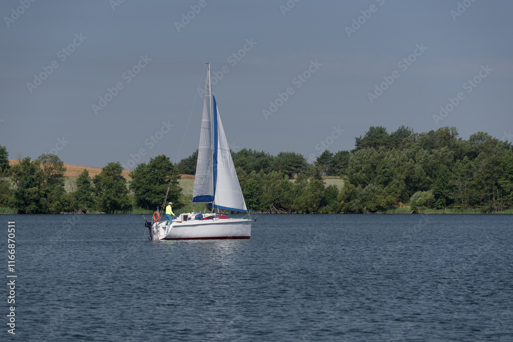 Obraz premium SAILBOAT - A sailor sails on a lake