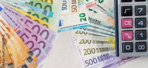 Euro paper cash with calculaor as finance background photo