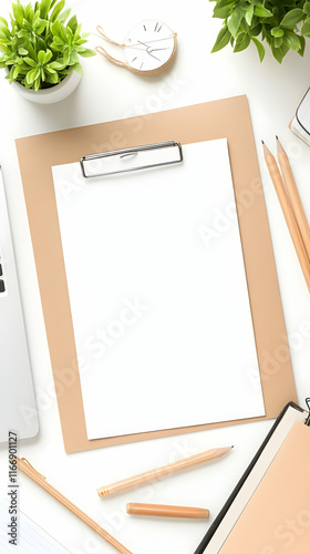 Blank notepad on minimalist workspace with pencils, plants, and laptop; ideal for mockup or office stationery advertisement.