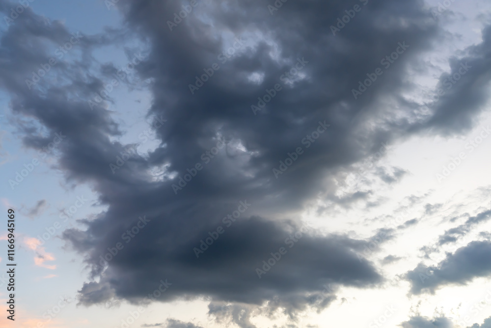 Fototapeta premium Low angle view of dark sky with strange shape of fluffy black clouds in the morning or evening while sunset or sunrise used as natural background texture in decorative art work