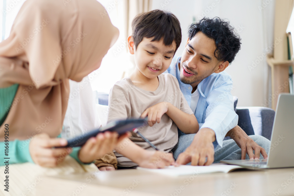 Asian muslim family relaxing in living room together. Asian muslim family relaxing in living room together.