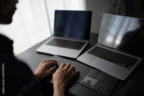 Asian man software engineer Working on Computer at office desk for writing program code IT Software Engineer finding errors tech support devops creating digital photo