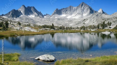 Majestic mountain range reflected in a serene alpine lake.