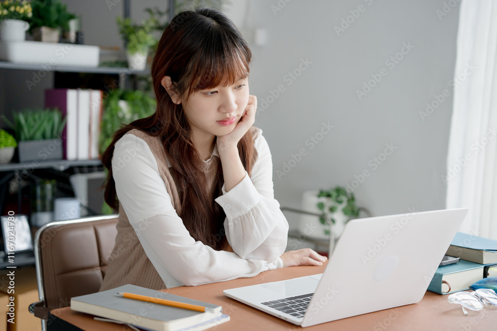 Asian woman watching video from online classroom Asian woman watching video from online classroom