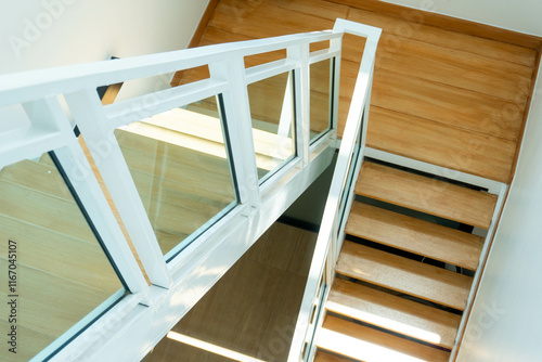 Modern wooden and glass staircase in new house interior.