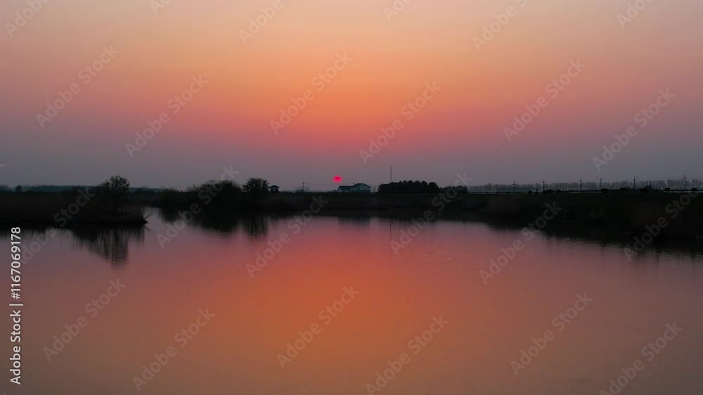 Stunning aerial view of sunset reflections in calm water at a serene location Stunning aerial view of sunset reflections in calm water at a serene location