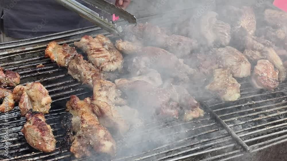 Close up shot of sizzling pork chop on a outdoor grill